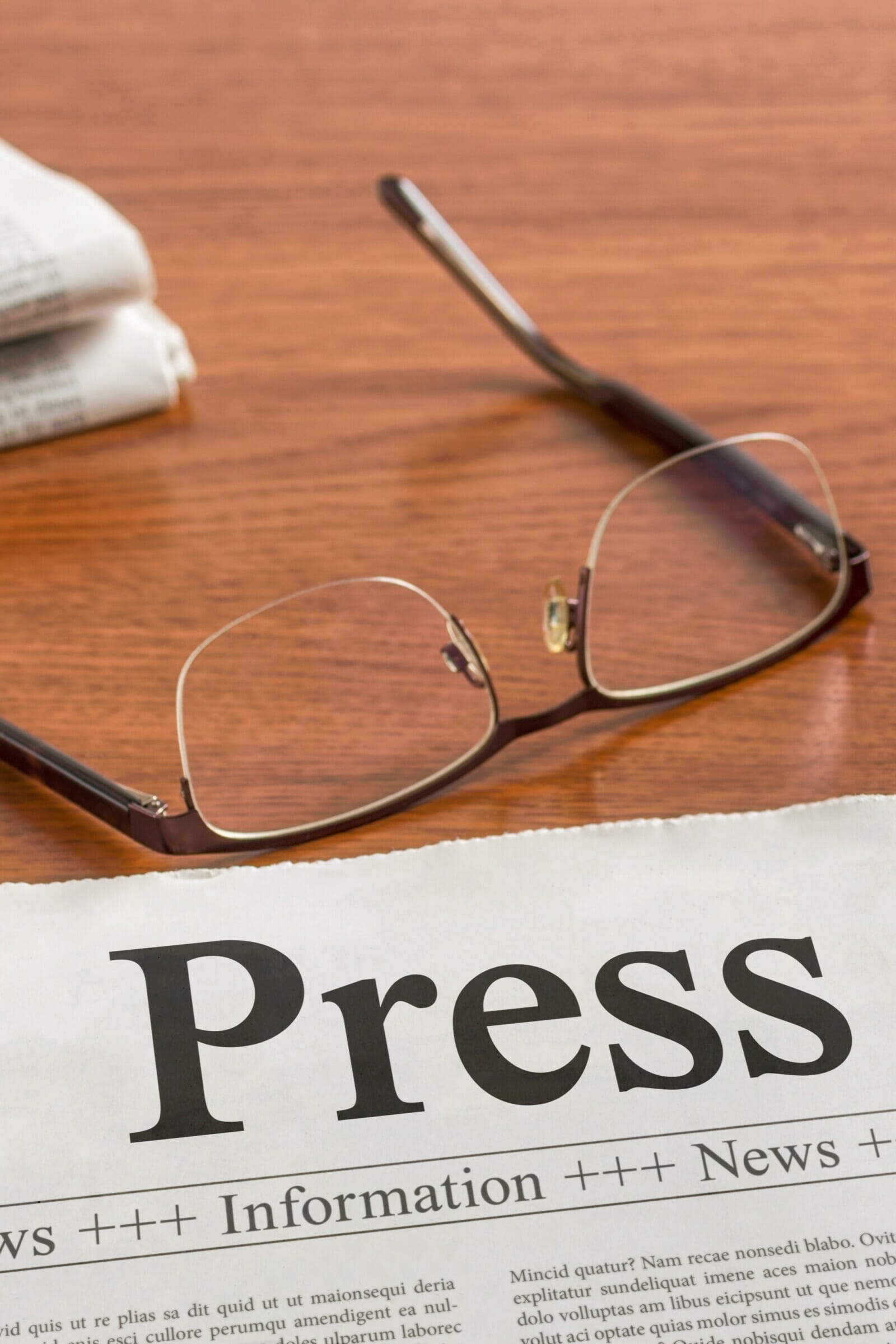 A newspaper on a wooden desk - Press Release