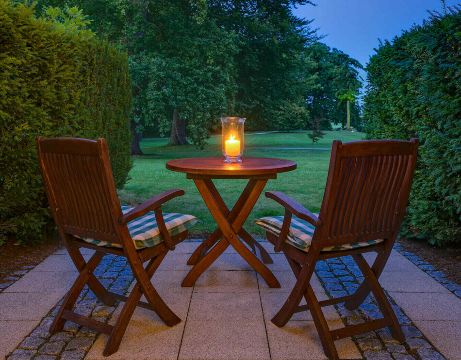 Eine kleine Terrasse mit Tisch und Stühlen im Schlosshotel Fleesensee.
